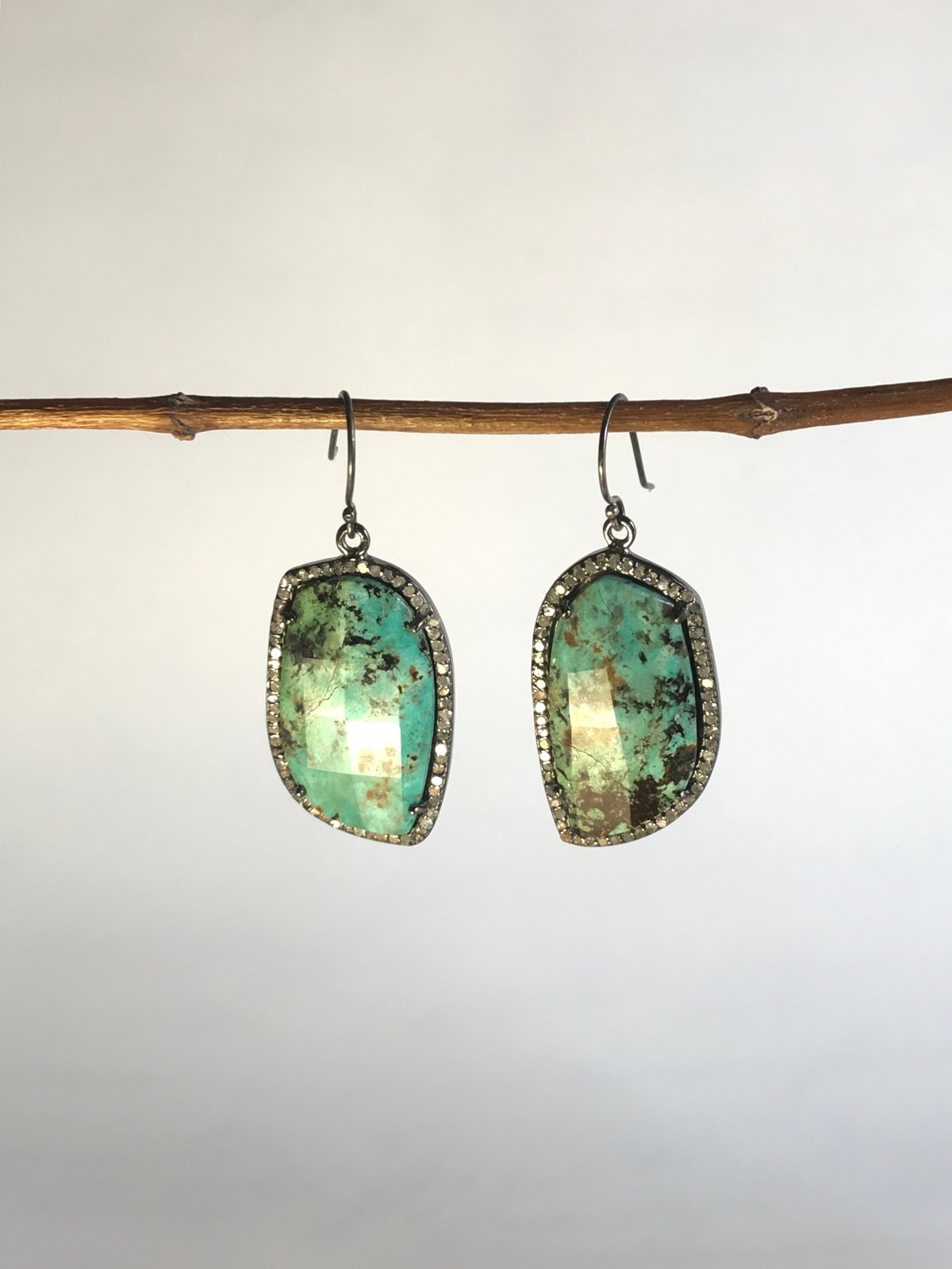 Faceted Turquoise Surrounded by Diamond