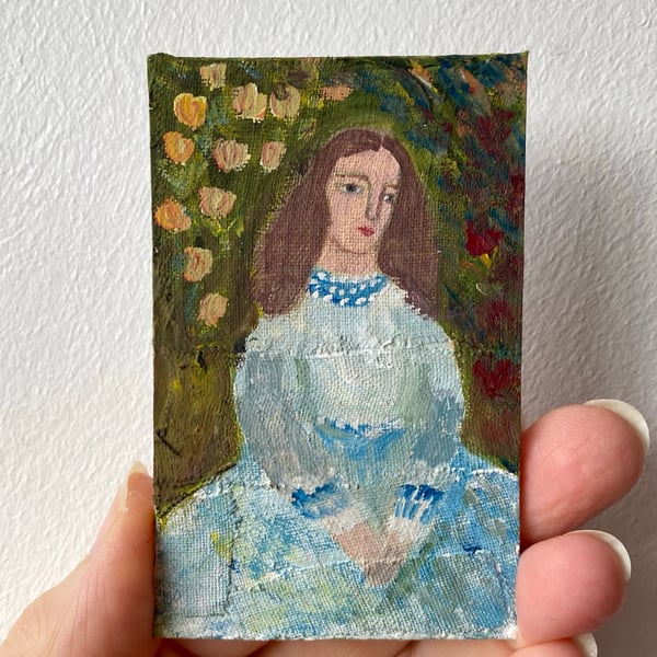 Image of portrait of a woman in a rose garden