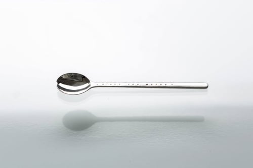 Image of small silver spoon with inscription in Latin