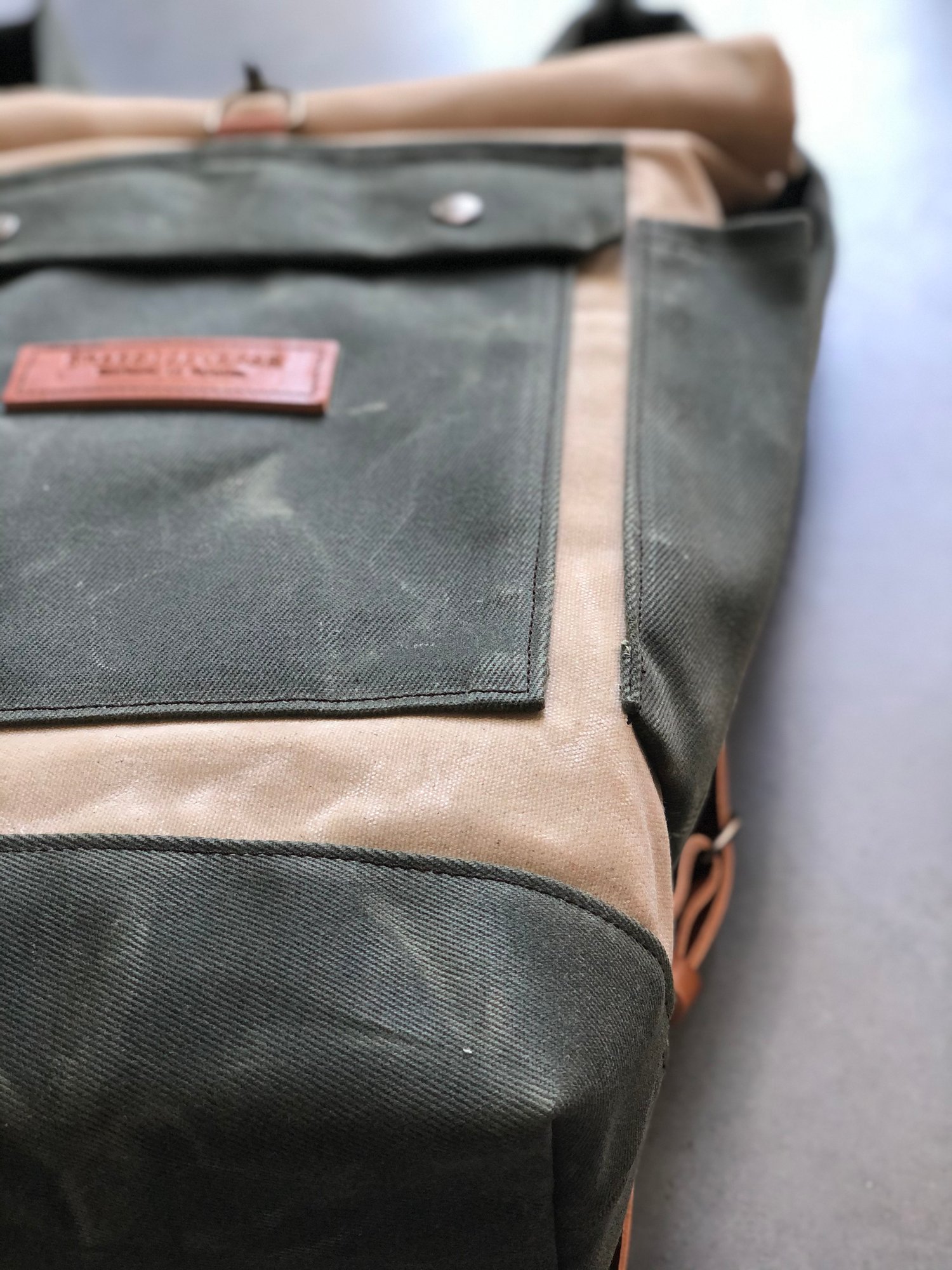 Image of Natural and olive green waterproof waxed canvas backpack medium size with padded shoulder straps 