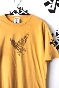 Image of fly in fly out tee in gold 