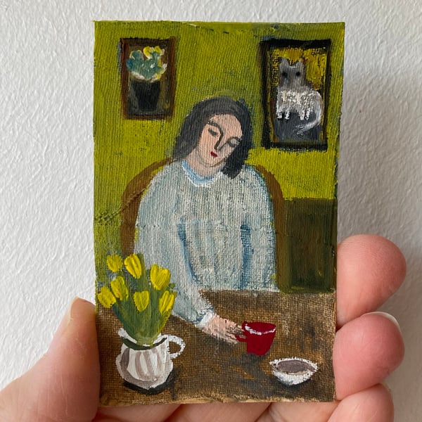 Image of woman at a table with red cup