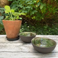 Image 3 of Small black clay bowl, white slip & green glaze interior