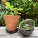 Small black clay bowl, white slip & green glaze interior