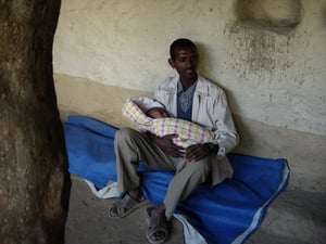 Image of Farmer cradling his baby by Alem Assefa (print)