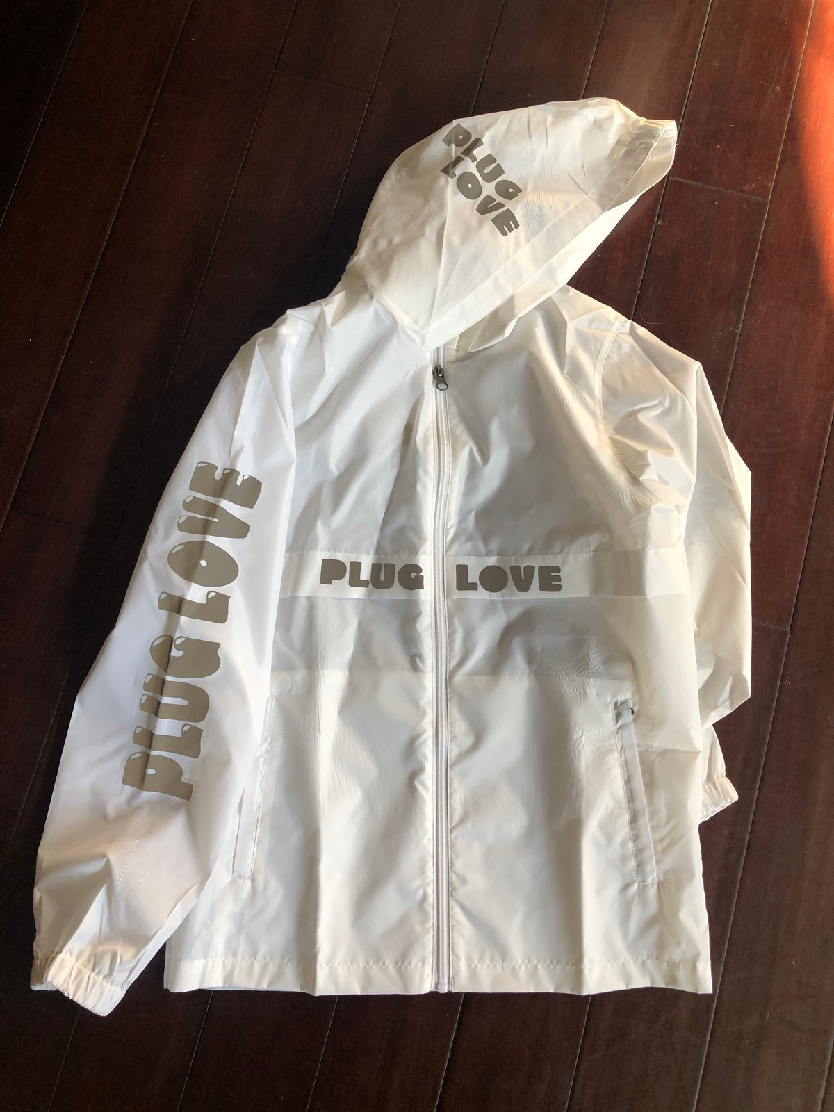 white reflective windbreaker