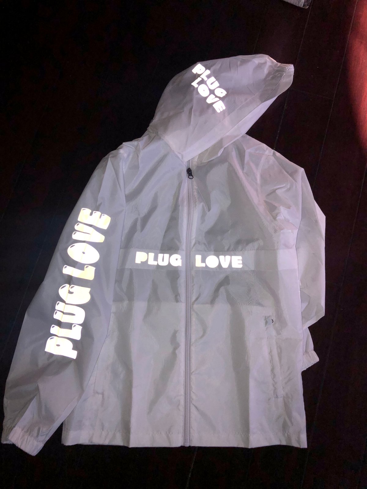 white reflective windbreaker