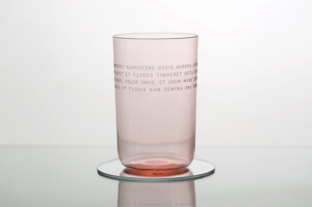 Image of VERBA pink water glass with inscription in Latin or Ancient Greek