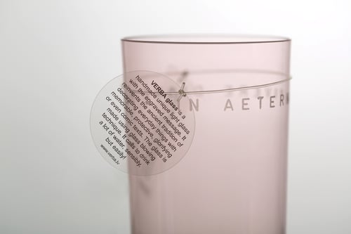 Image of VERBA pink water glass with inscription in Latin or Ancient Greek
