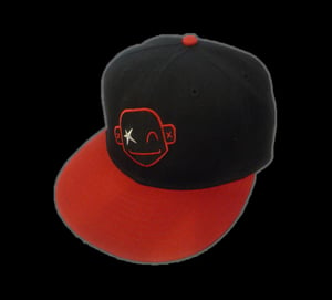Image of Black skitz cap with red peak