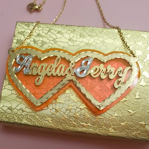 Double Heart Couples Nameplate Necklace w/ Pink Background 