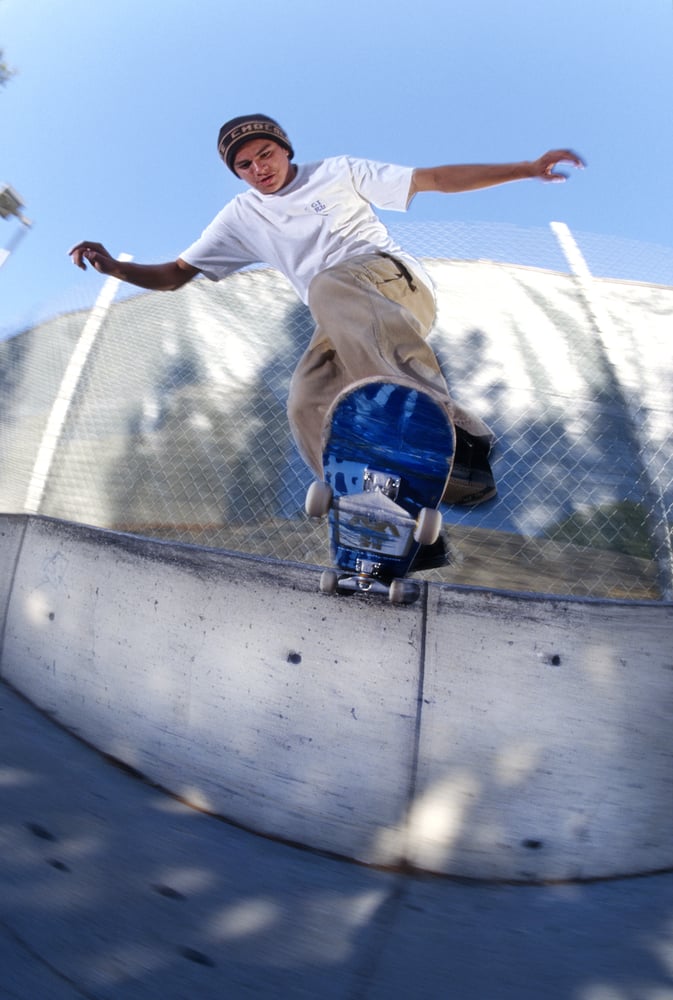 Chico Brenes, backside tail slide, downtown San Francisco 1996 by Tobin Yelland