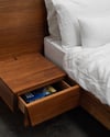 FLOATING BED WITH CLIPPED WING DRAWERS IN TASMANIAN BLACKWOOD