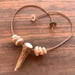 Image of Axis deer antler spike shed necklace with tiger puka shells and a sliding seaglass clasp