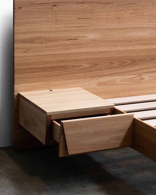 FLOATING BED WITH CLIPPED WING DRAWERS IN BLACKBUTT