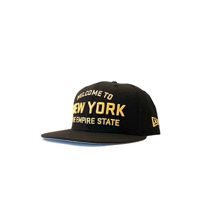 Image of 2520 X NEW ERA WELCOME TO NEW YORK THE EMPIRE STATE  9FIFTY SNAPBACK - BLACK/MANILLA 