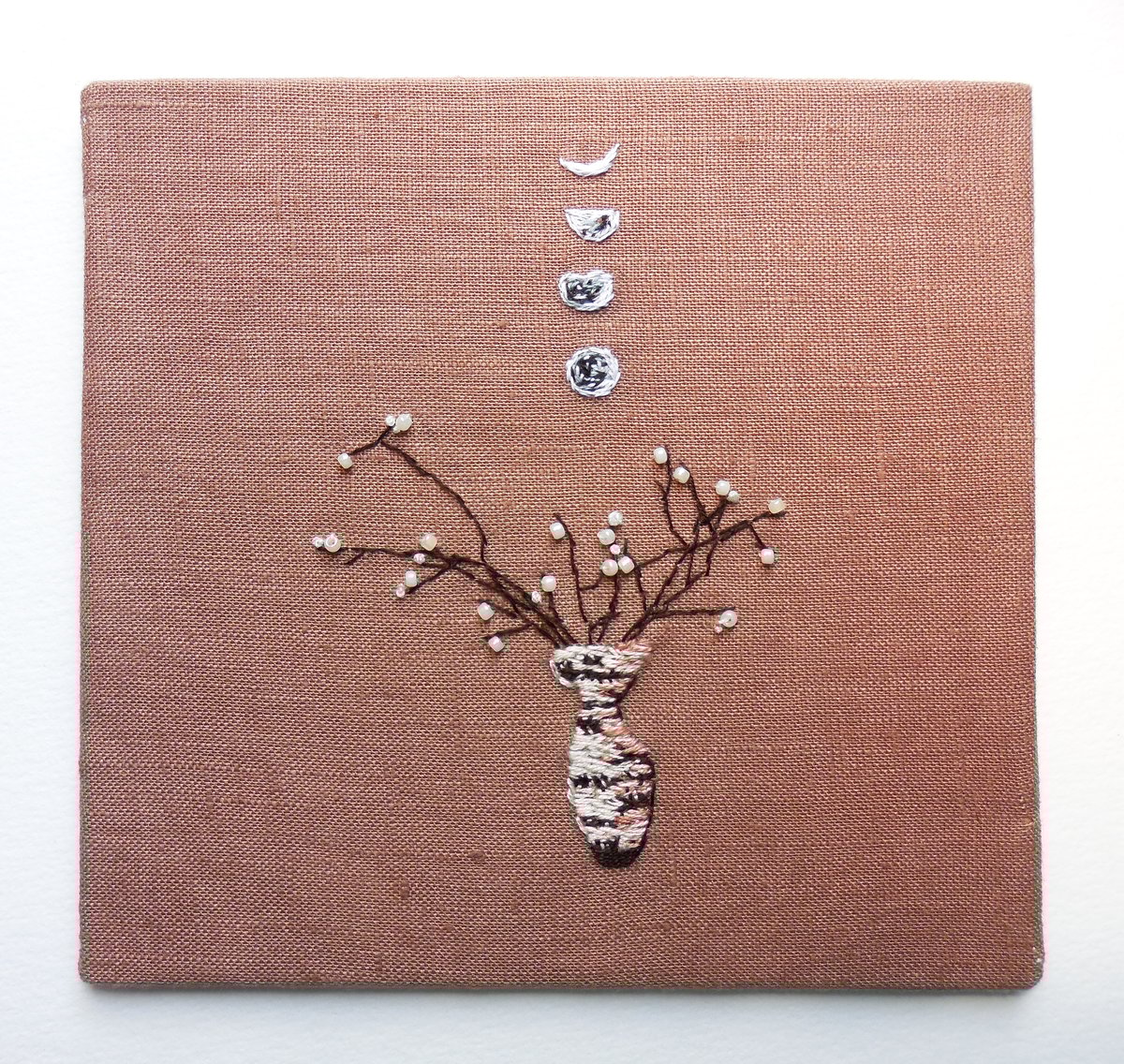 Image of the moon phases and a vase - embroidery artwork