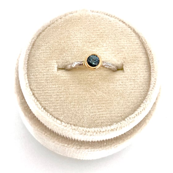 Image of teal Montana sapphire engagement ring . twig band