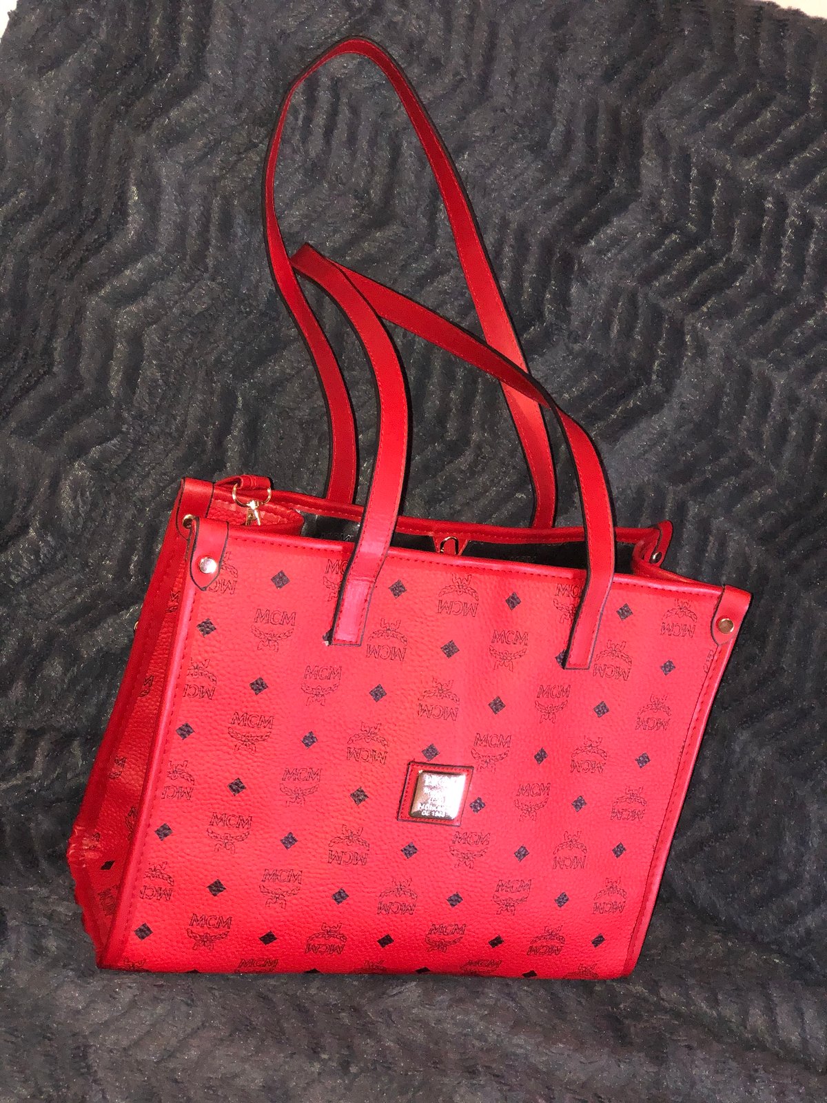 red mcm duffle bag