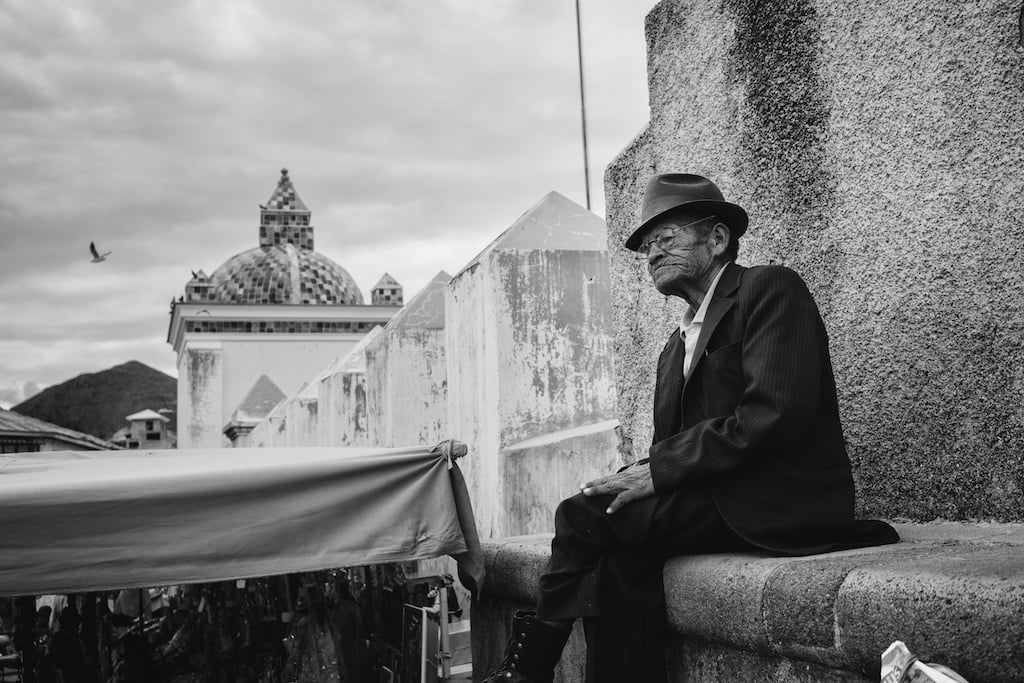 Old Man Sitting On a Church Wall