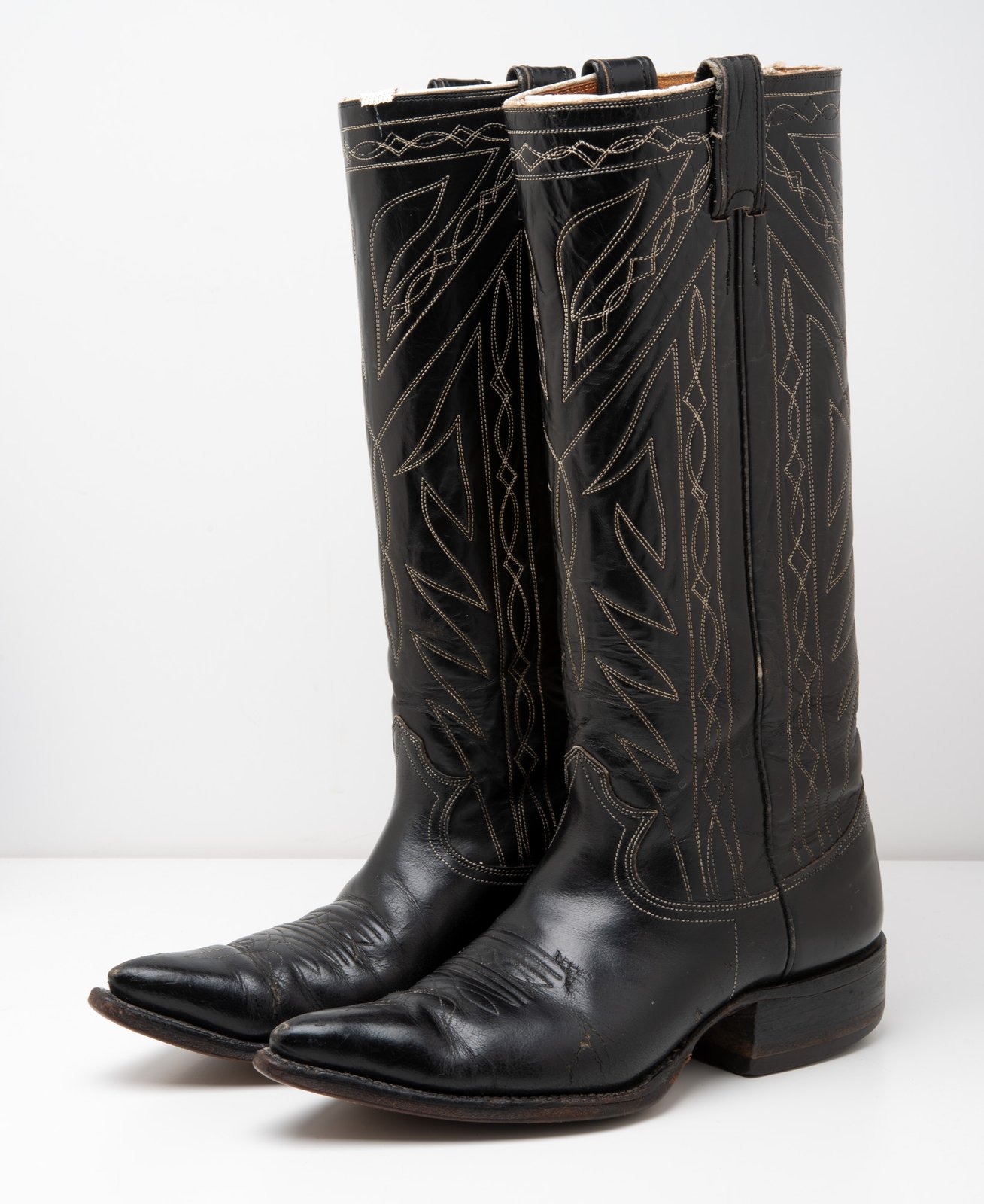 black boots with white stitching