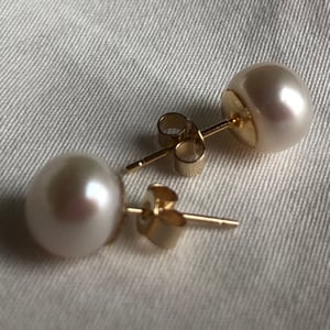 7.3mm White Pearl Earrings On Gold Backs.