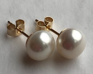 7.3mm White Pearl Earrings On Gold Backs.