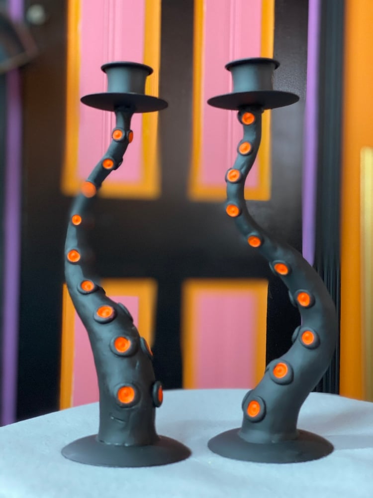 Image of Flat black and orange candlestick. 