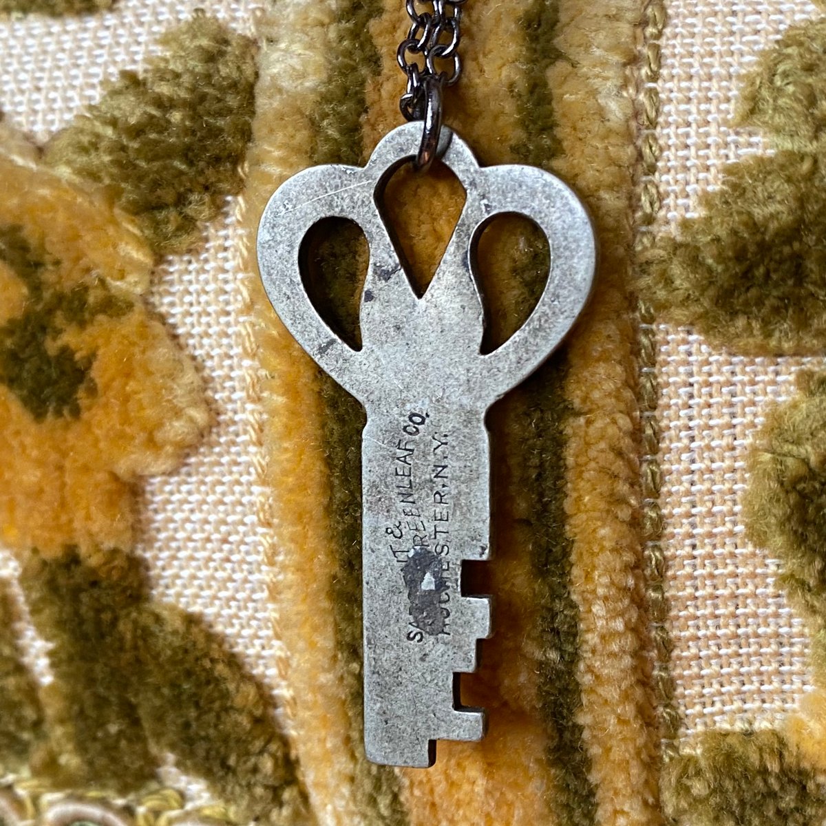 Small Ornate Flat Silver Key on Gunmetal Chain | kristen llewellyn