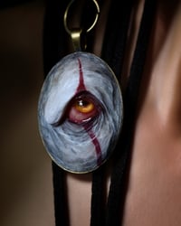 Image 1 of Pennywise Eye glow in the dark pendant OOAK