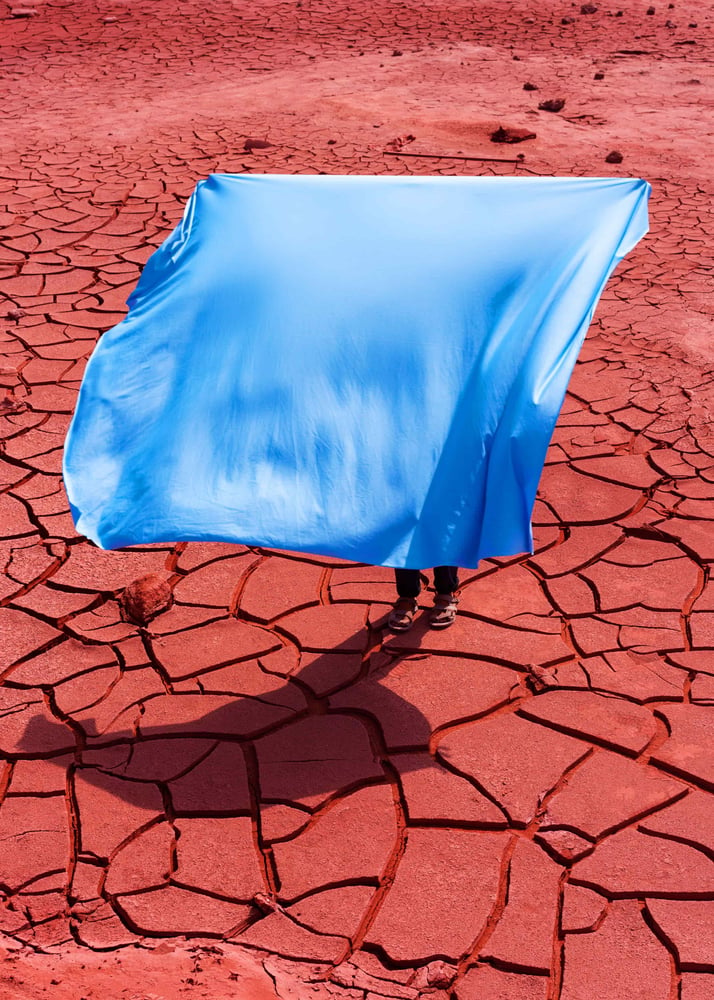 Image of Red soil, blue fabric