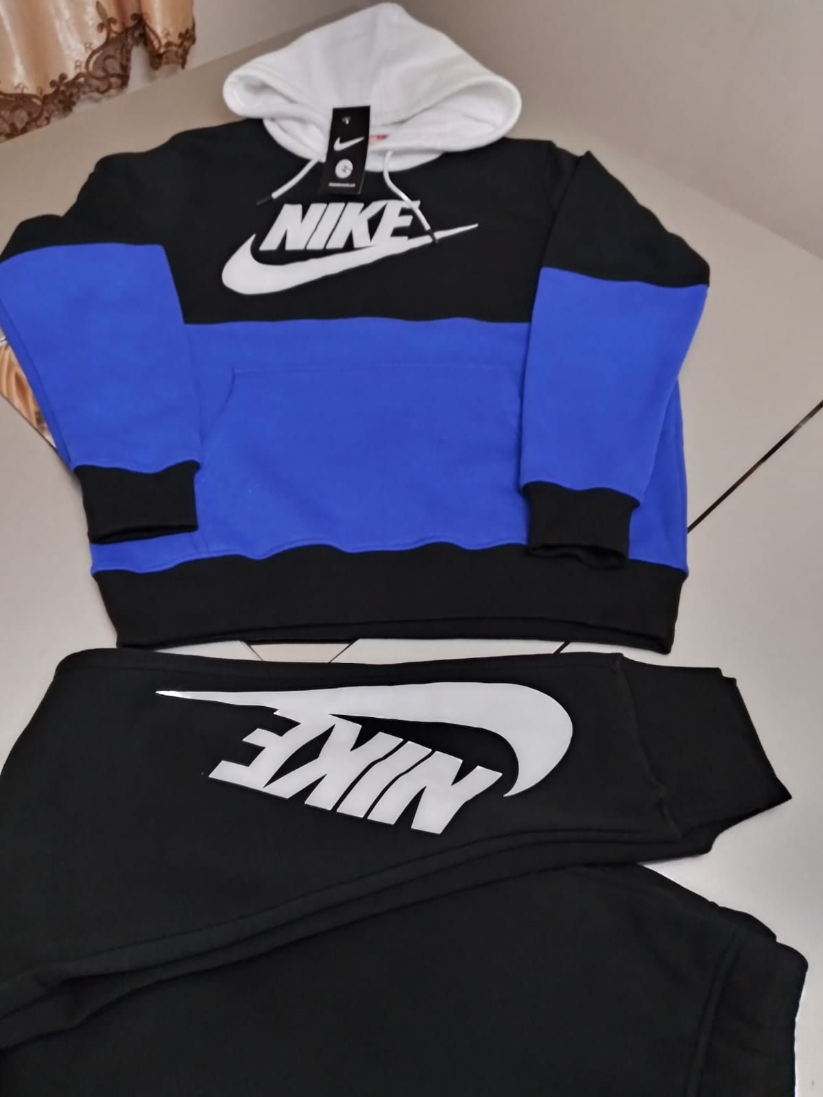 blue and white nike jogging suit
