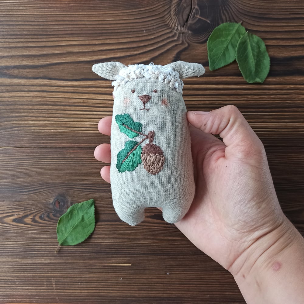 Image of Stuffed sheep with acorn embroidery