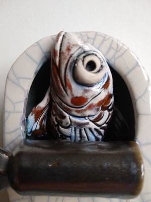 Goldfish emerging from a tin