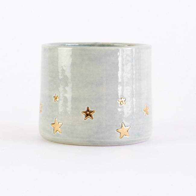 Golden star decorated teacup in sage green glaze