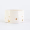 Golden star decorated teacup in white glaze 