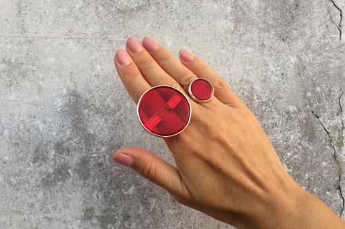 Image of "The sun warms.." silver ring with red plexiglass · OMNIA SOL TEMPERAT.. ·
