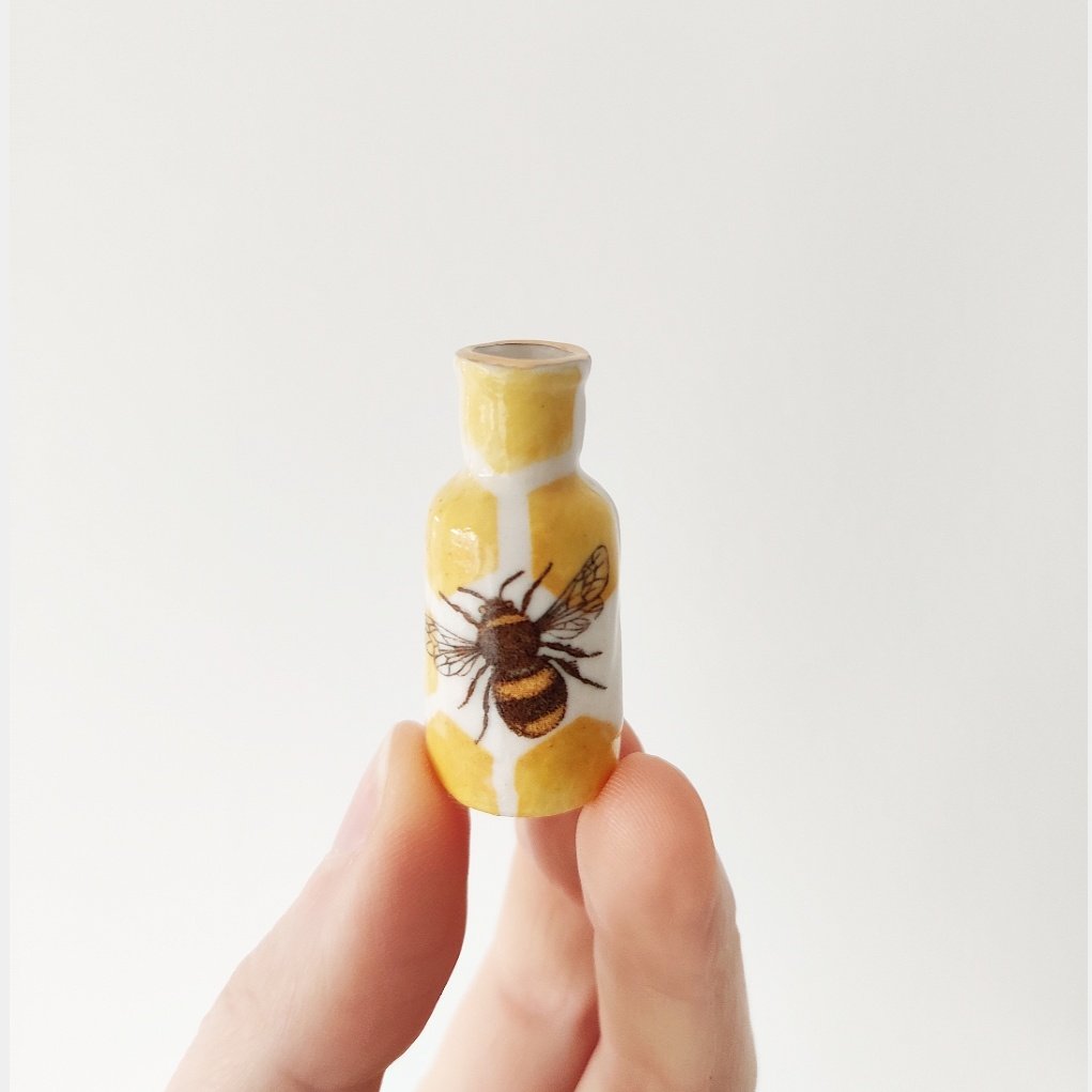 Tiny porcelain bee bottle