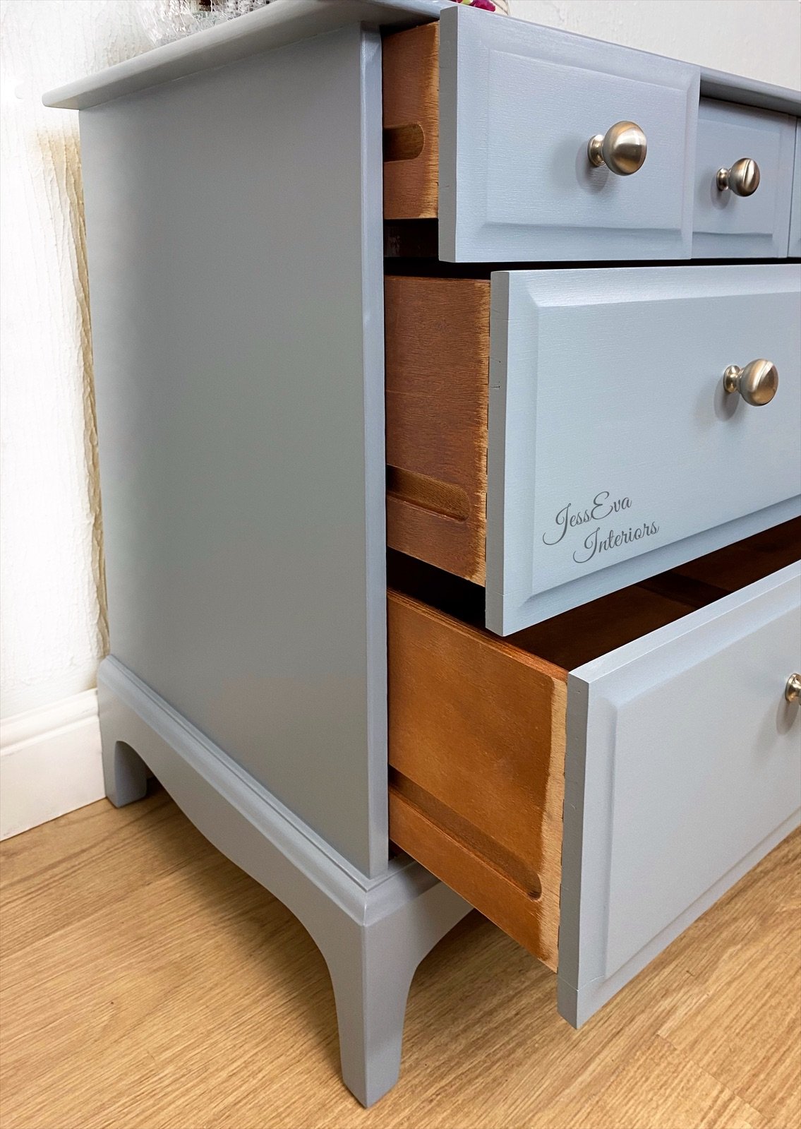 Stag Minstrel CHEST OF DRAWERS painted in light grey with blue tone.