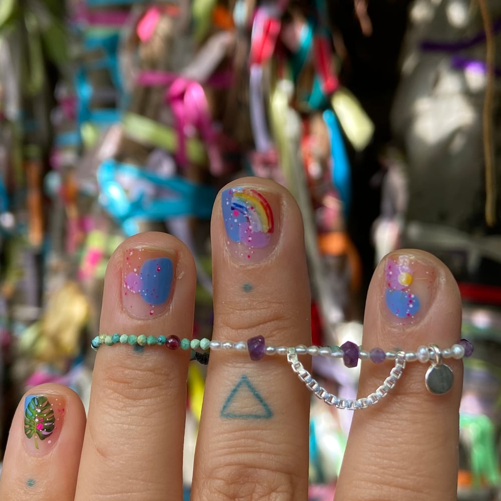 Image of tiny stones and charm bracelet