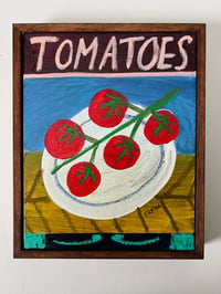 Tomatoes plate on blue and olive green