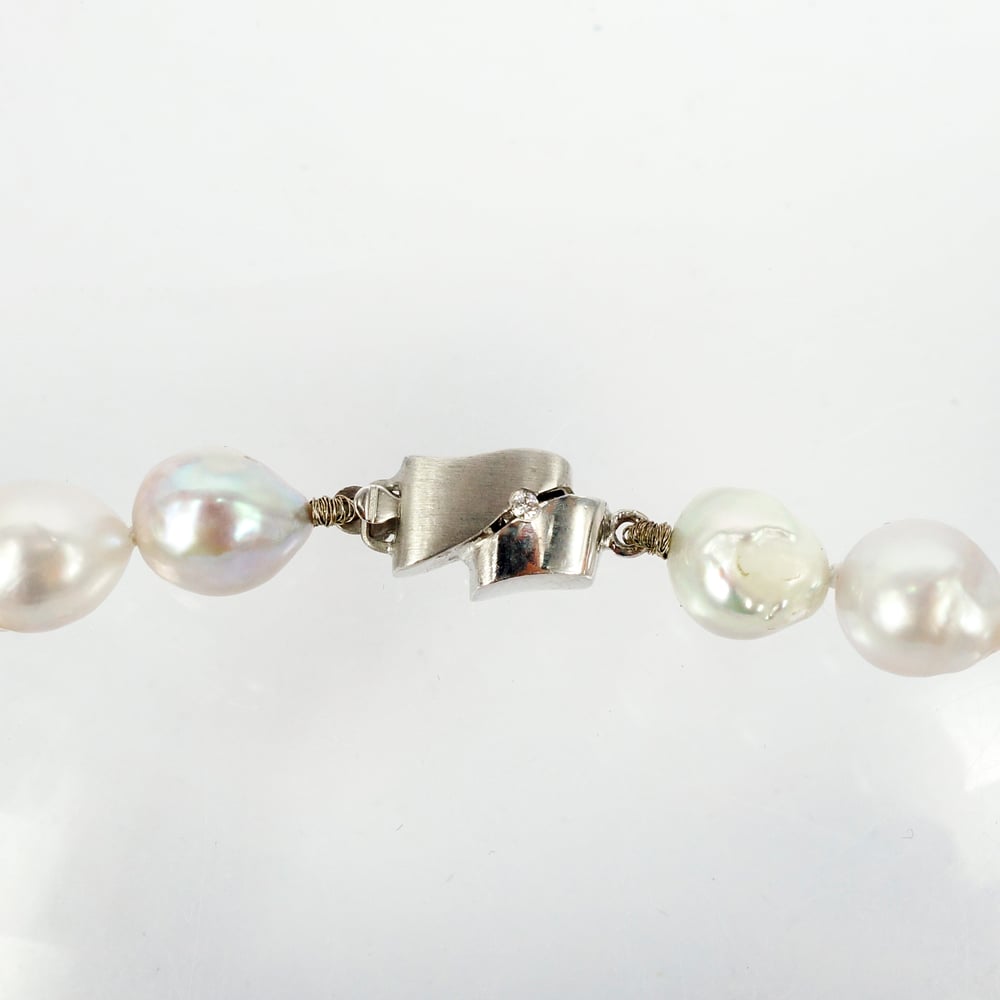 Image of Pearl strand with 14k white gold diamond set clasp. cp0274