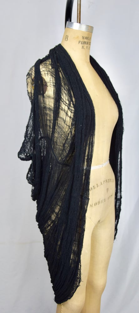 Image of Spider web cardi cape. 