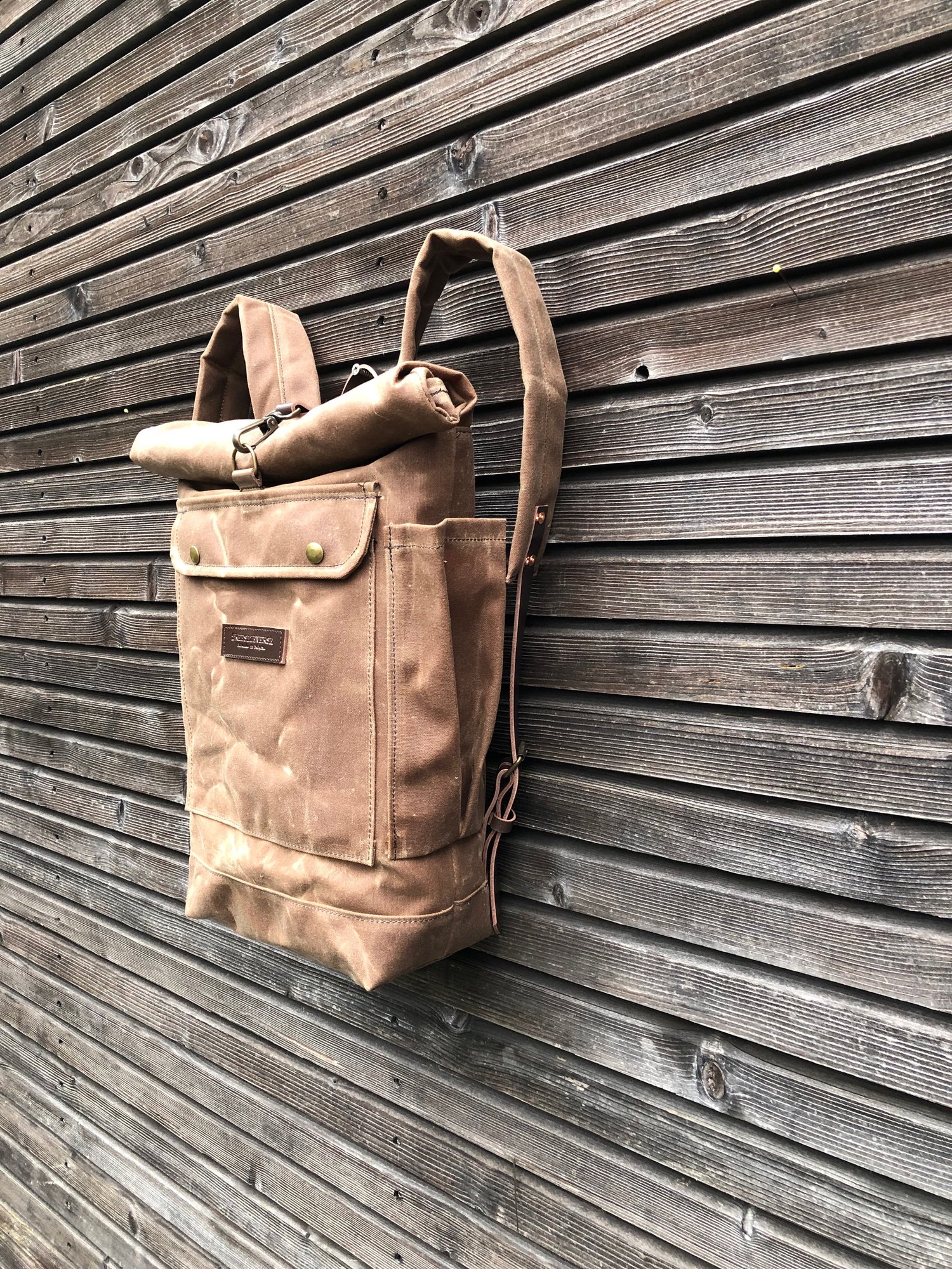 Image of Waxed canvas rucksack / waterproof backpack with roll up top and double waxed bottom