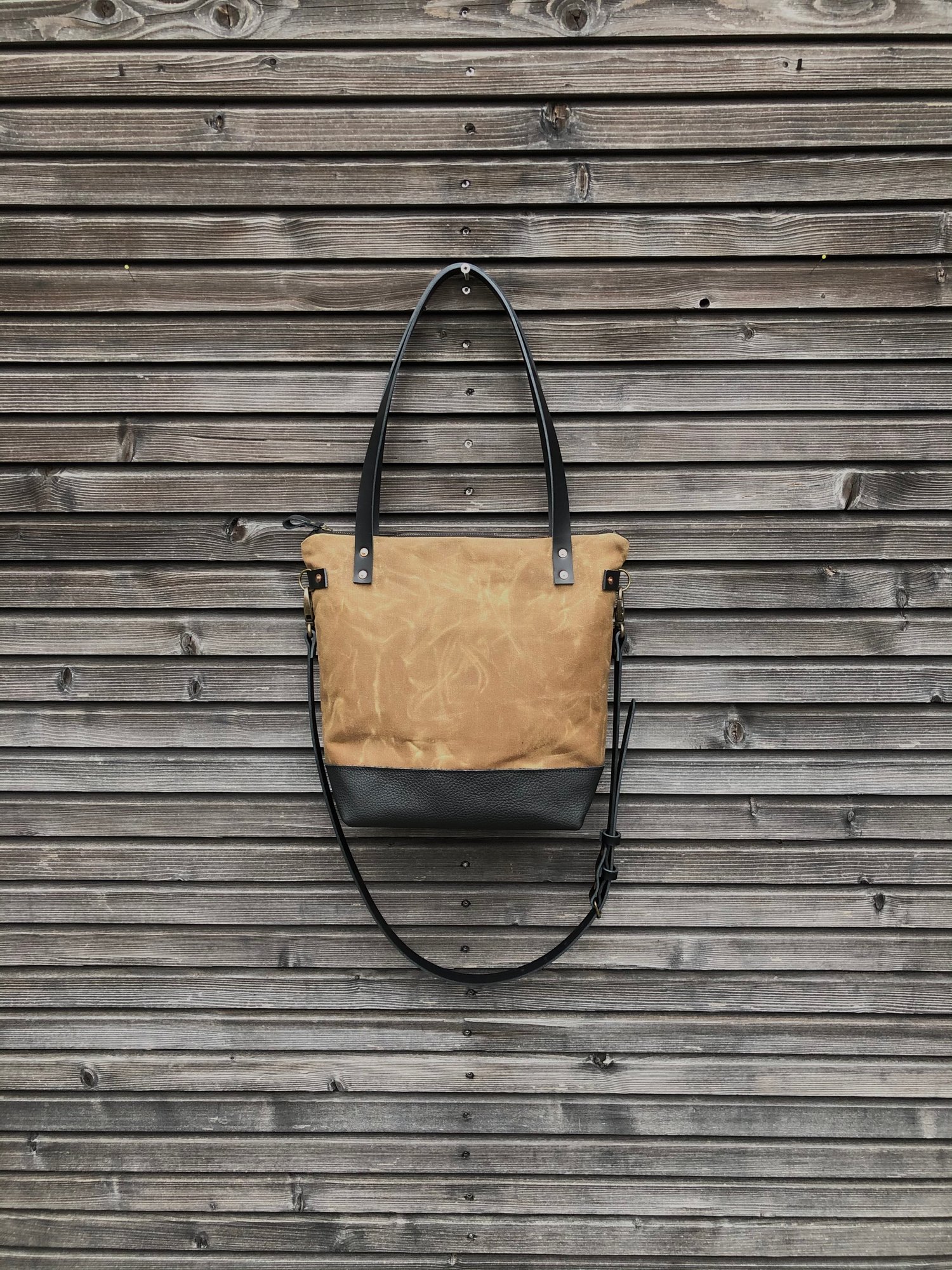 Image of Waxed canvas tote bag in spice with zipper closure and cross body strap