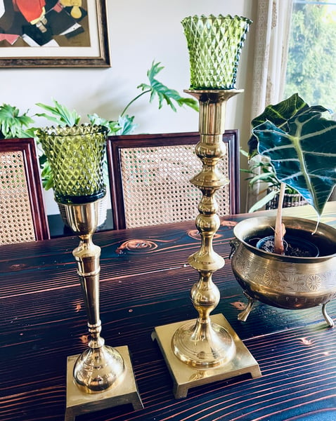 Image of A pair of vintage brass Candlestands. Tall and medium. Paired with vintage votives.