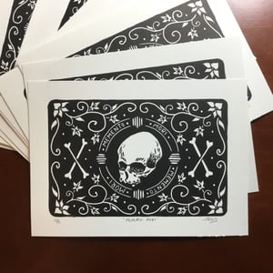 Memento mori skull and bones linocut print.