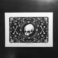 Image 1 of Memento mori skull and bones linocut print.