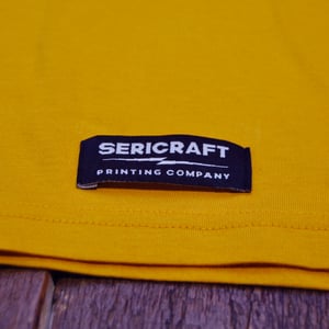 Image of SERICRAFT EMBLEM TEE - YELLOW