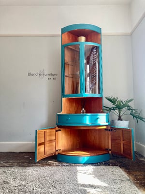 Image of Nathan Corner Drinks Cabinet unit with light in vibrant teal
